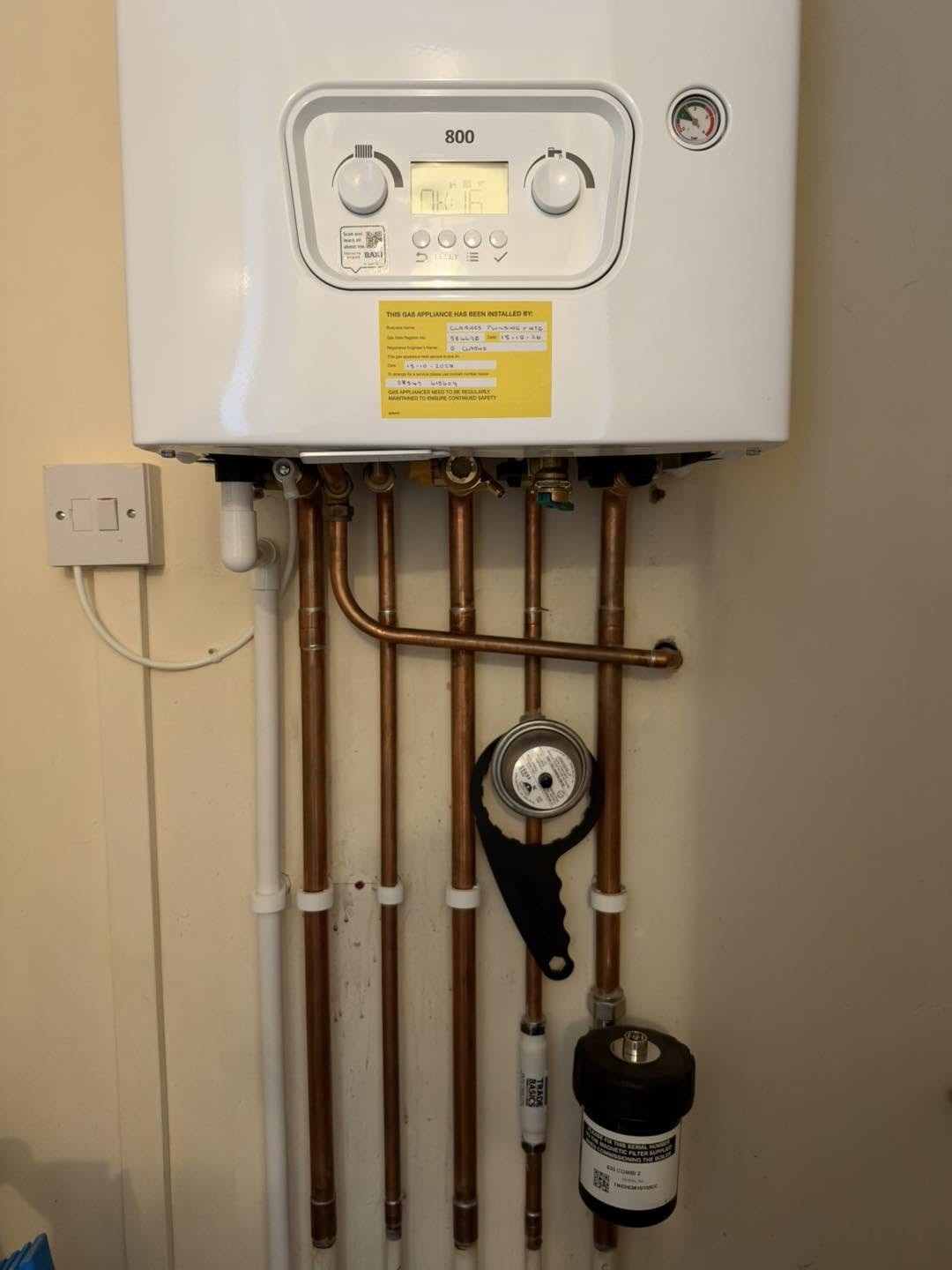 White combi boiler with new copper pipework and a magnetic filter below