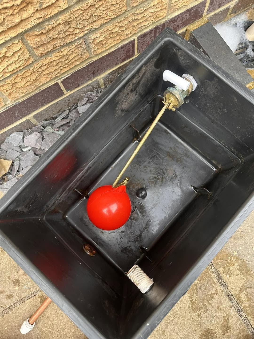 The same cold water cistern cleaned, with a new red ball valve float