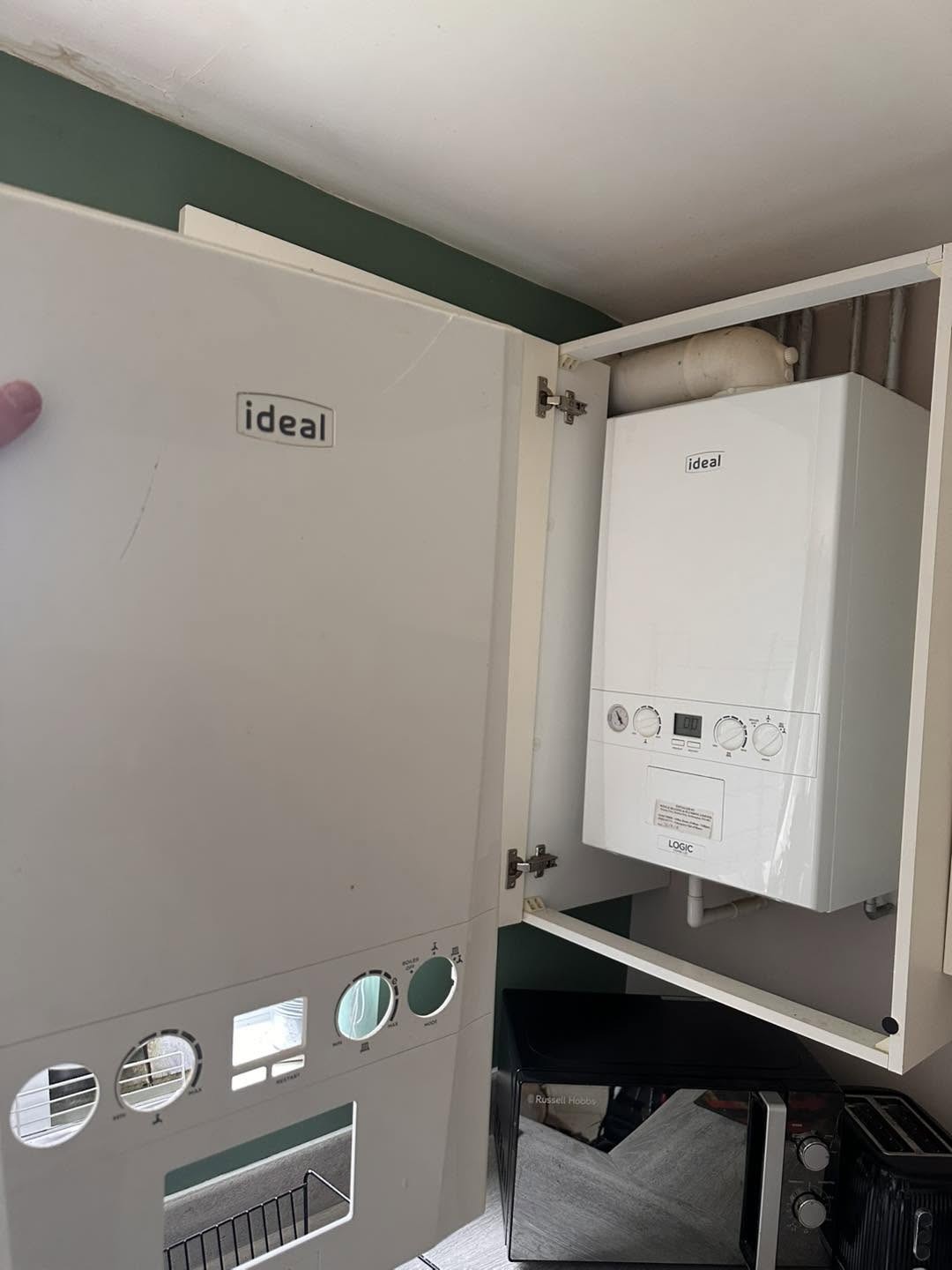 Ideal combi boiler fitted inside a kitchen wall cupboard