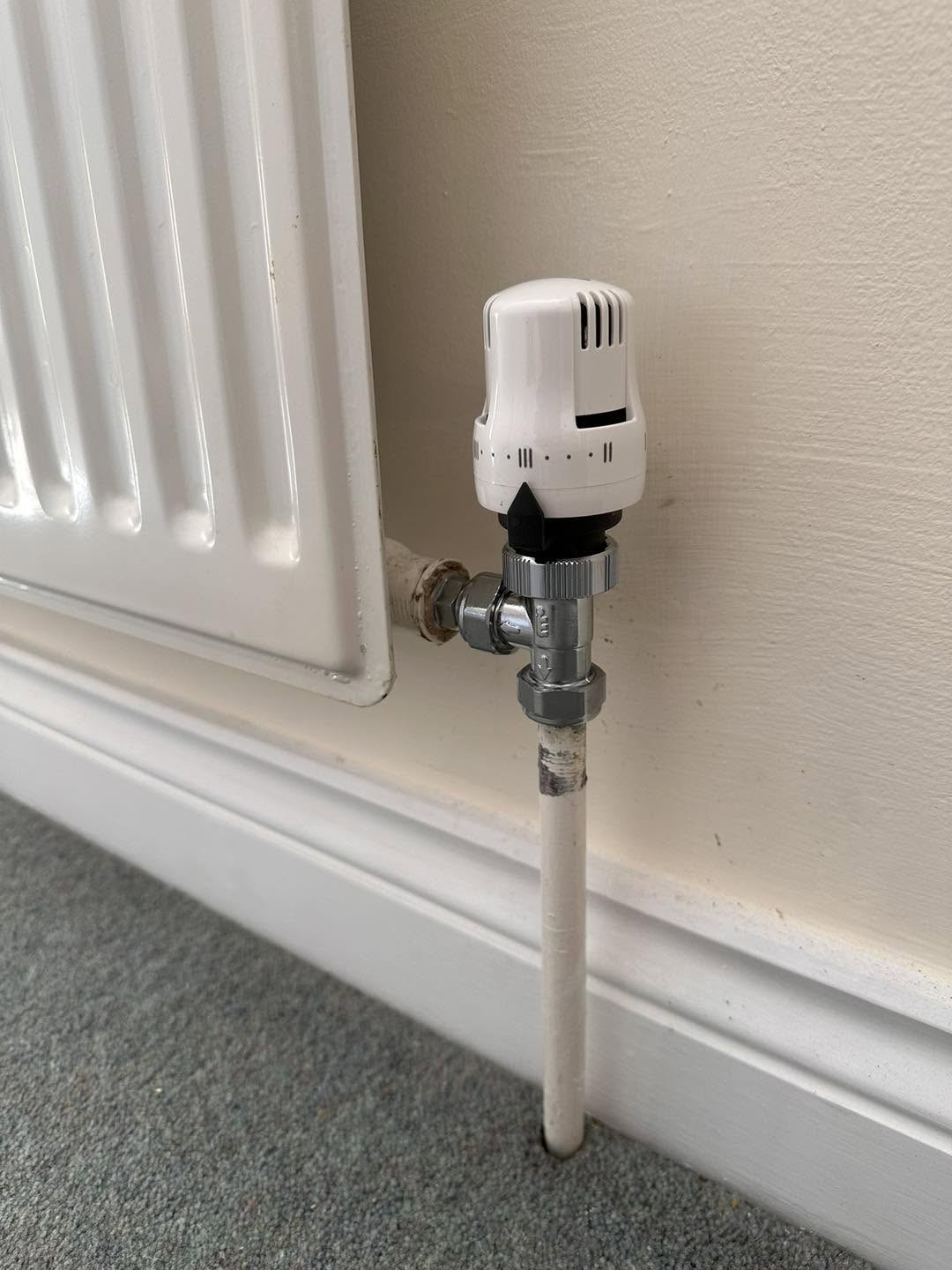 White thermostatic radiator valve on a new radiator